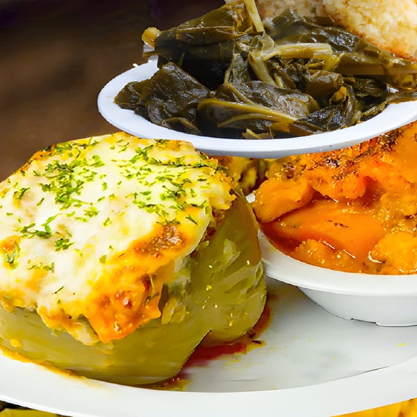 A Mikki's Soul Food Cafe meal with stuffed bell pepper, collard greens, and candied yams.