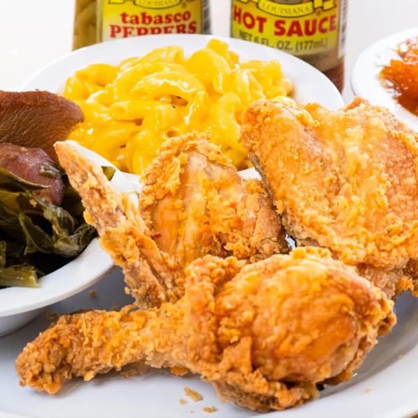 Mikki's Soul Food Cafe fried chicken, mac and cheese, collard greens, and candied yams.