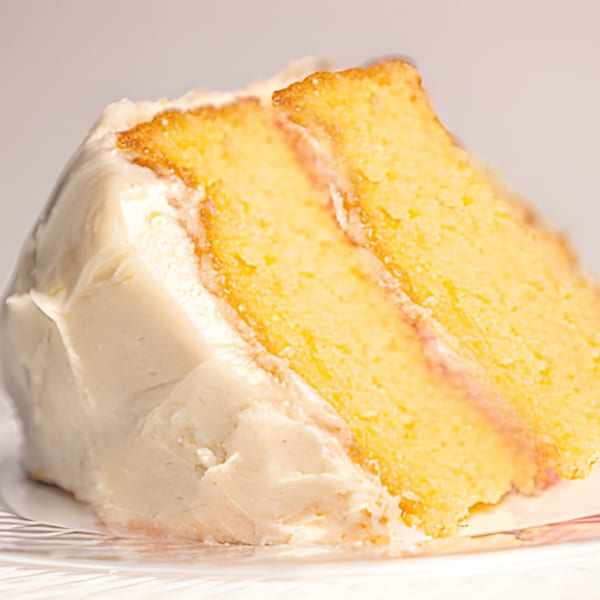 A close-up of a slice of Mikki's Soul Food Cafe's yellow cake with white frosting.